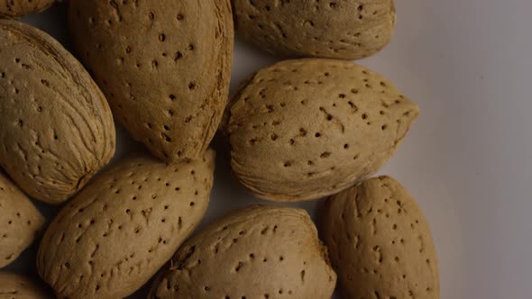 Cinematic, rotating shot of almonds on a white surface - ALMONDS