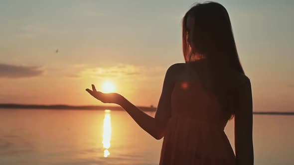 The Young Girl Releases the Sun From Her Hands