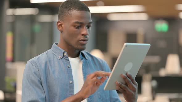 Young African American Man Having Loss on Tablet