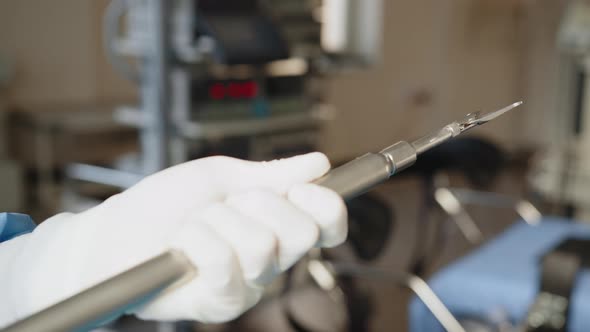 Scrub Nurse Prepares Medical Instruments for Surgery