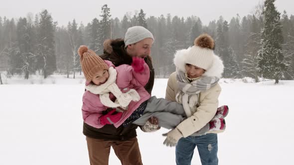 Parents Carrying Daughter in Winter Park