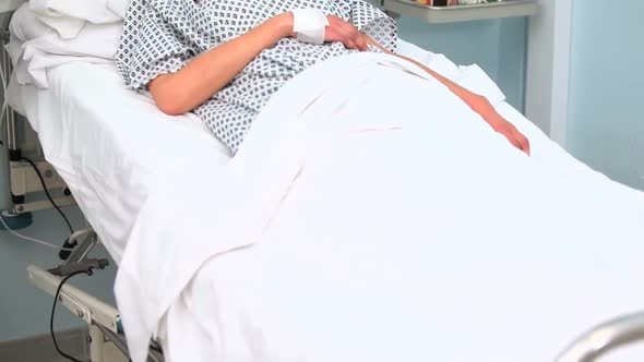 Female patient lying on a bed while closing her eyes
