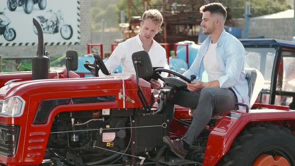 Attractive Man Buying a Tractor at Outdoor Shop