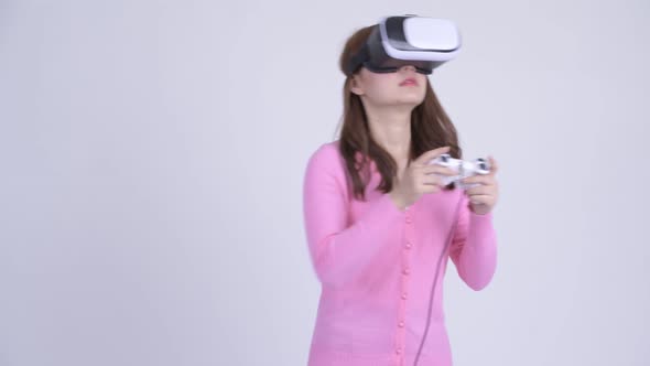 Young Asian Nerd Woman Playing Games and Using Virtual Reality Headset