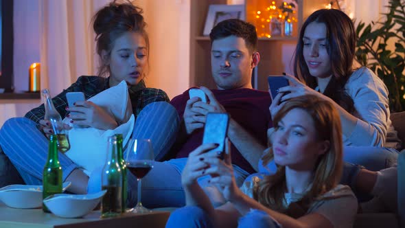 Friends with Smartphone Watching Tv at Home