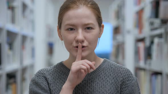 Young Woman Gesturing  Silence, Finger on Lips, Indoor