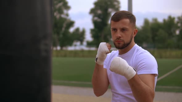 Young Man Punching Punch Bag