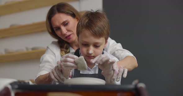 Mother and Son Doing Pottery Together in Studio