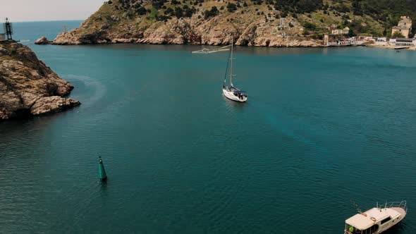 Sailing yacht goes to the open sea. Maritime navigation.