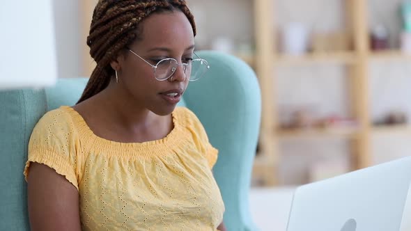 Young Beautiful Businesswoman is Working with Laptop While Sitting in Chair at Home Room Spbi