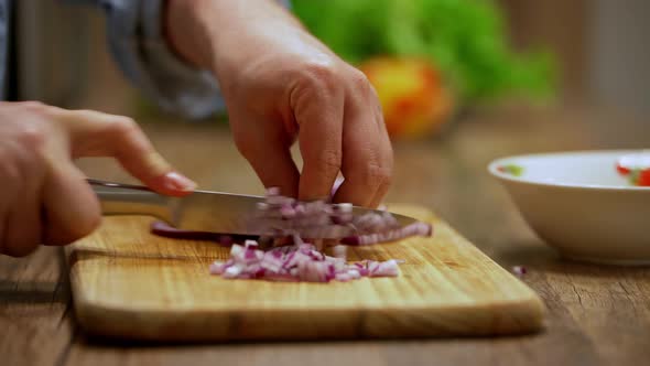 a man cuts an onion. cooking process by the chef. salad ingredients. caring man preparing dinner