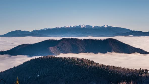 Winter Alps Mountains above Foggy Clouds in Cold Sunny Morning Landscape