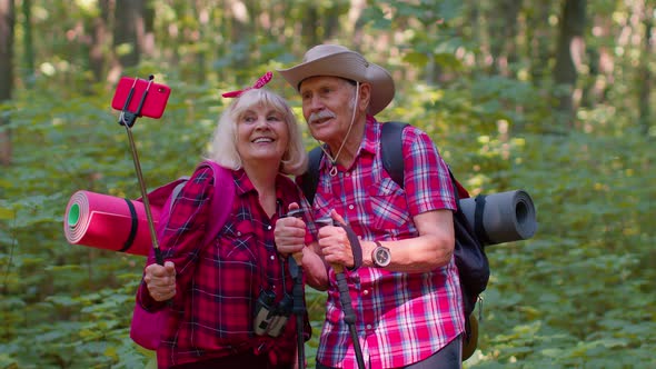 Senior Grandmother Grandfather Blogger Tourists Taking Selfie Photo Portrait on Smartphone in Forest