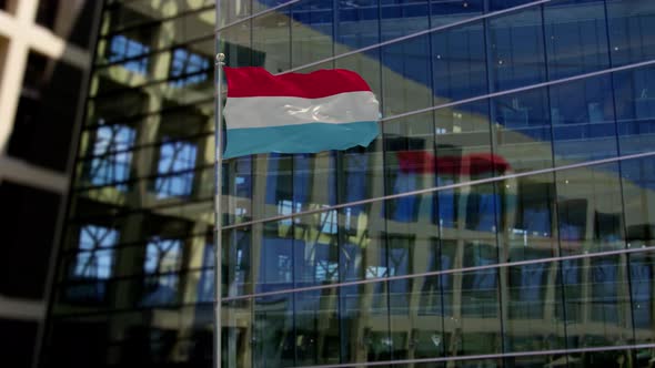 Luxembourg Flag Waving On A Skyscraper Building