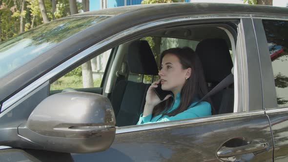 Lovely Female Driver Talks on Phone in Traffic Jam