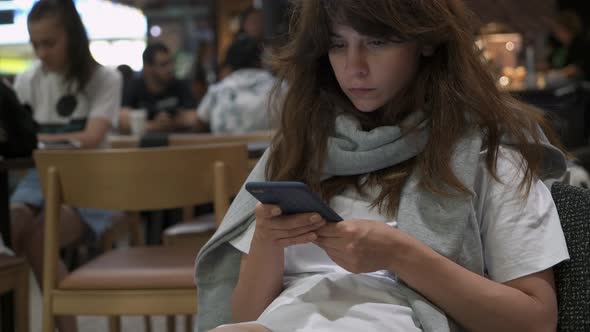 Gimbal Middle Shot of Woman with Long Hair Texting in the Phone