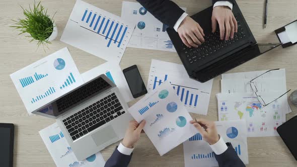 Auditors Checking Business Documents of Company, Working on Laptops, Top View