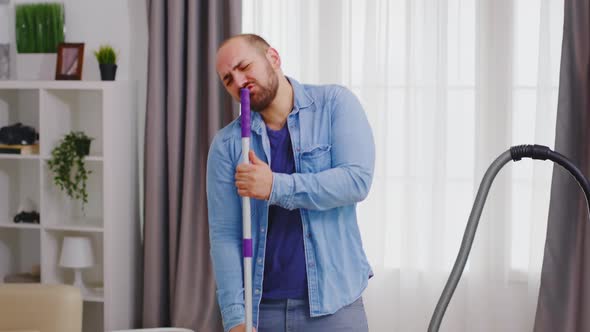 Cheerful Man Singing on Mop