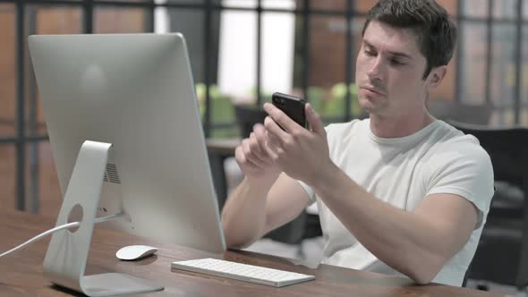 Man Using Smartphone at Work