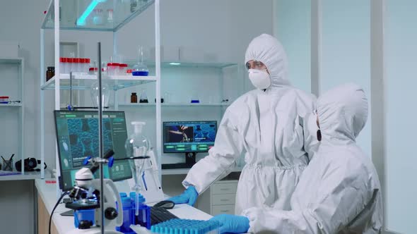 Biotechnology Scientist Wearing Ppe Suit Researching alt