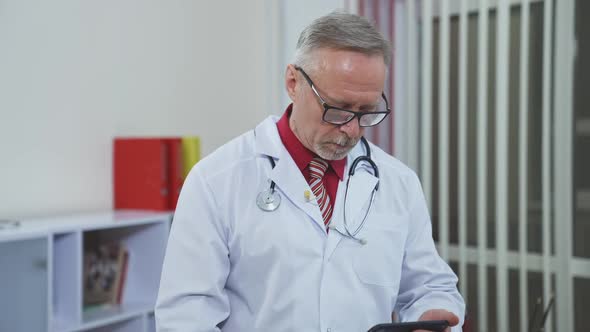 Professional doctor using mobile phone for medical consultation. 