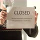 Owner of the Institution Hangs a Closed Sign on the Window - VideoHive Item for Sale