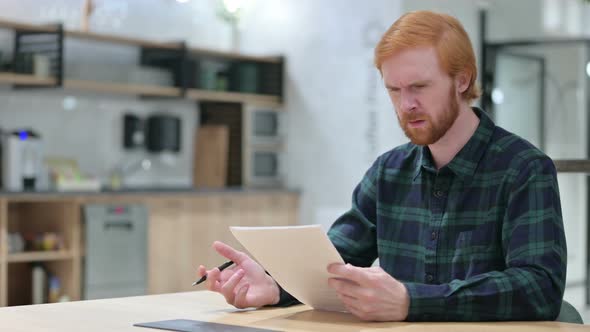 Beard Redhead Man Feeling Disappointed on Documents 
