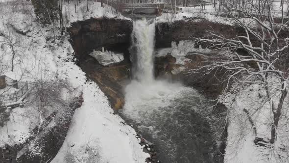 aerial footage waterfall in Minnesota, USA during winter time