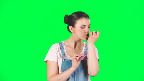 Girl with Two Hair-buns and Red Lips Makes Herself Manicure with Pink Nail File, Slow Motion