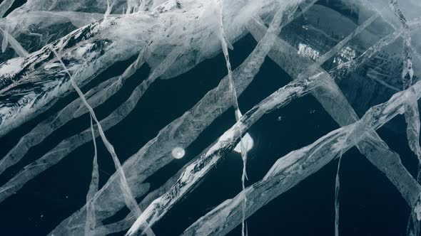 Cracks in Transparent Blue Ice of Frozen Baikal Lake Dolly Motion Close Up View