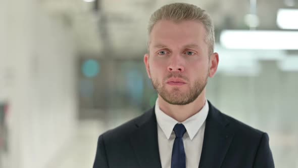 Portrait of Sick Young Businessman Coughing