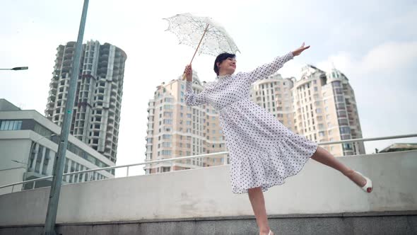 Wide Shot Happy Woman Having Fun Standing on One Leg Smiling on City Street