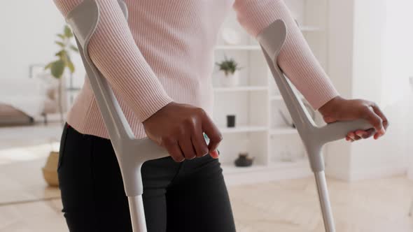 Unrecognizable Black Female Holding Crutches Having Impairment Indoor Cropped