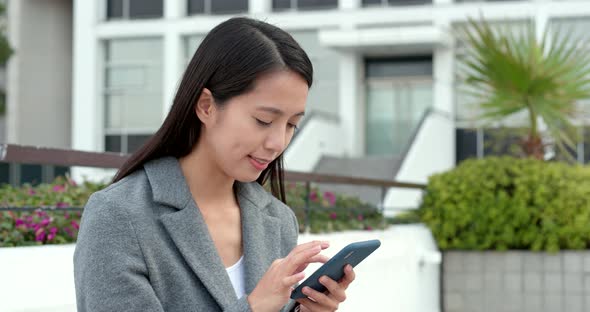 Businesswoman check on smart phone in city