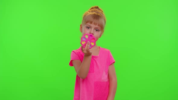 Girl Playing Spinning with Pop It Sensory Antistress Toy in Park Stress Anxiety Relief Chroma Key