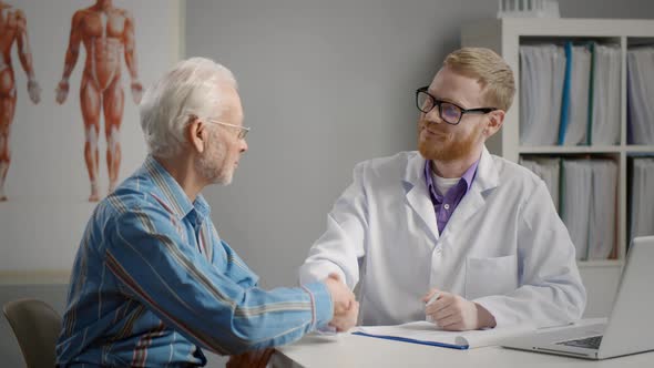 Senior Patient Shaking Doctor Hand at Appointment