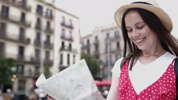 Young Woman Exploring Barcelona While Checking a Guide Map in the Street