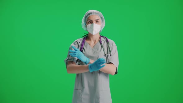 Portrait of Young Female Doctor in Protective Gear and Medical Mask Woman Looks at the Camera