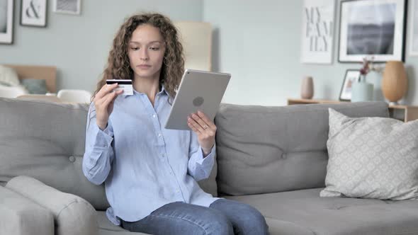 Online Shopping on Tablet by Curly Hair Woman Sitting on Couch