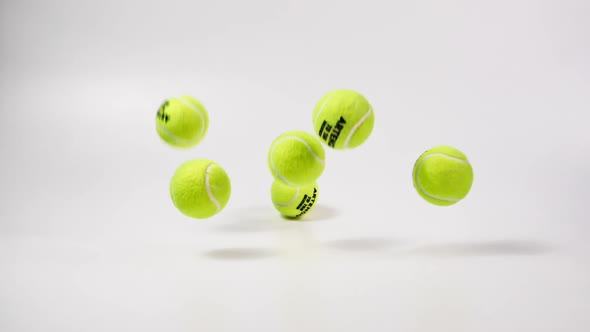 Group of Tennis Balls Falling and Bouncing in Slow Motion