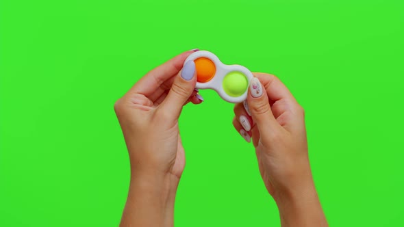 Hands Holding Colorful Silicone Bubbles Sensory Toy Simple Dimple Isolated on Chroma Key Background