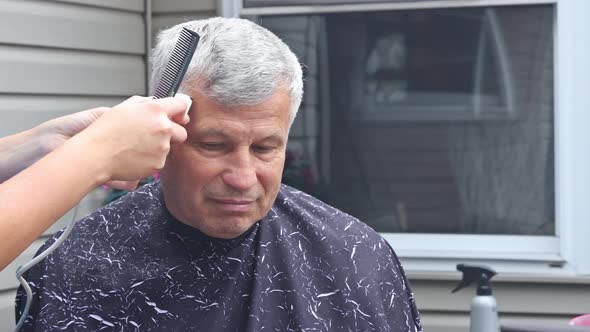 A Hairdresser Stylish Haircut for a Man in a Home