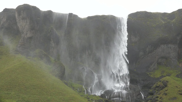 Iceland. Famous Waterfall In Iceland Water Flowing Through High Cliffs Inspiration Epic Scale Nature