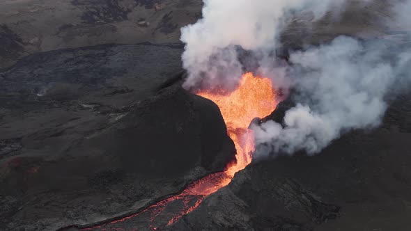 Active volcano emitting smoke and lava