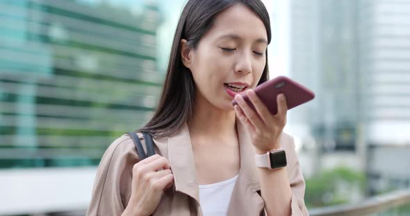 Woman sending audio message on mobile phone