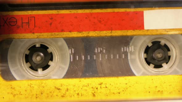 Yellow Audio Cassette in the Tape Recorder Playing and Rotates