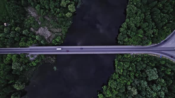 Top Aerial View to the Car on the Old Bridge Over the River