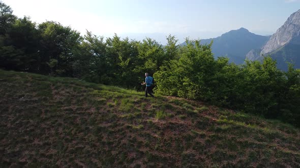 Hiker walking on mountain path, Lecco, Italy