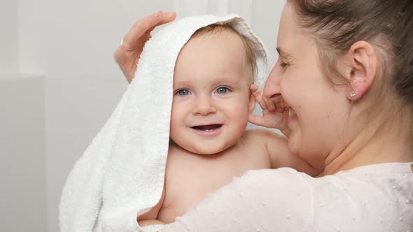 Portrait of Smiling Baby Boy Hugging Mother and Smiling After Washing in Bath