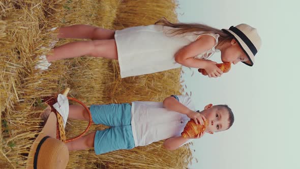 Vertical Screen Slow Motion Children Chewing Croissants in Countryside